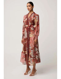 Woman wearing a patterned dress on a white background