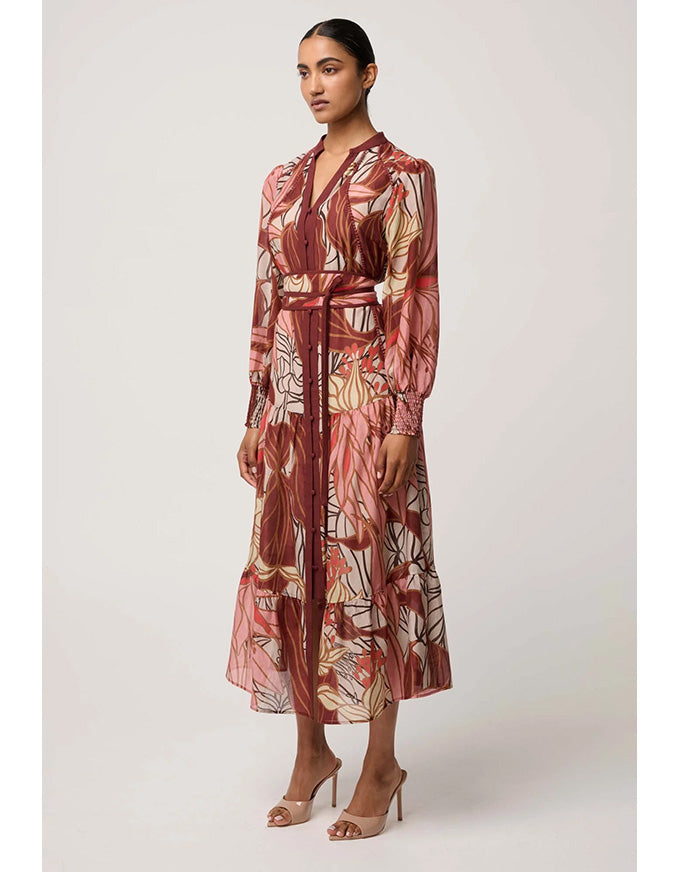 Woman wearing a patterned dress on a white background