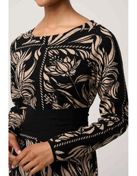 Black and beige patterned long-sleeve top on a plain background