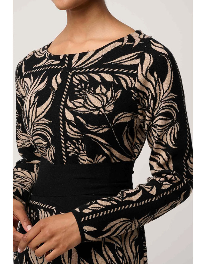 Black and beige patterned long-sleeve top on a plain background