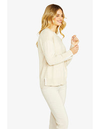 Woman wearing a cream-colored outfit on a white background