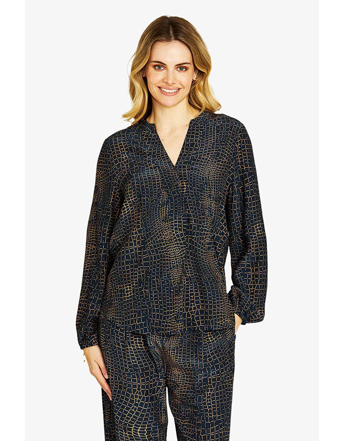 Woman wearing a patterned outfit on a white background