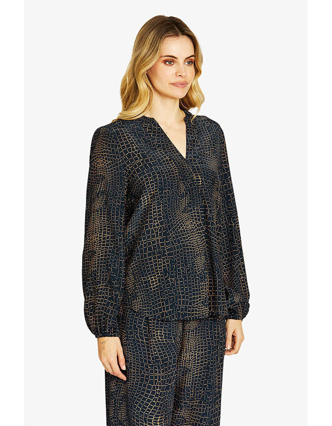 Woman wearing a black patterned outfit on a white background