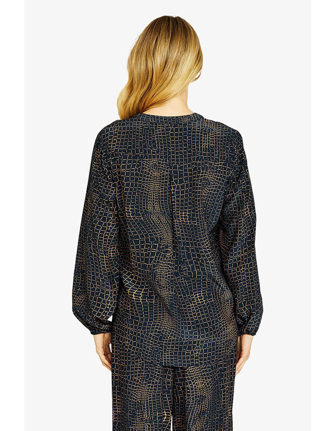 Person wearing a black patterned outfit on a white background