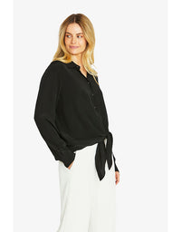 Woman wearing a black shirt with a tie detail on a white background