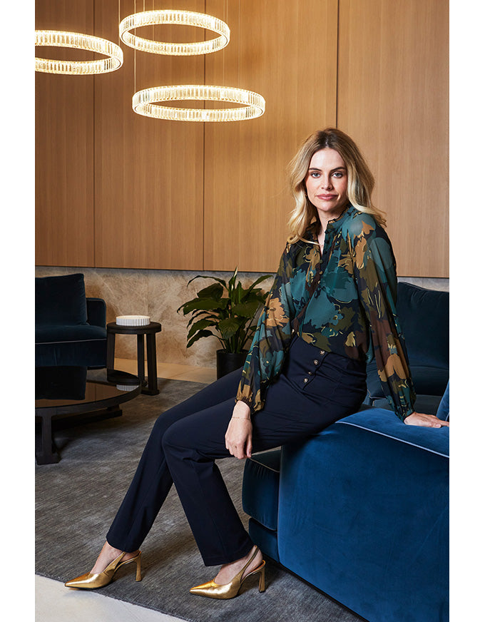 Woman sitting on a blue couch in a modern interior setting