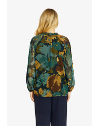 Woman wearing a floral blouse with a white background