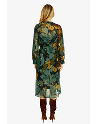 Woman wearing a long floral dress with a white background