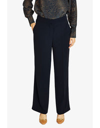 Person wearing navy high-waisted pants on a white background