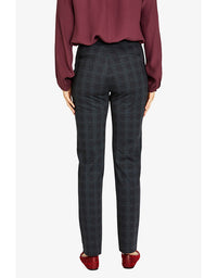 Person wearing a burgundy blouse and gray checkered pants on a white background