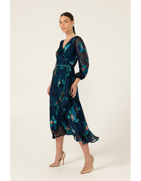 Woman wearing a dark blue floral dress on a beige background