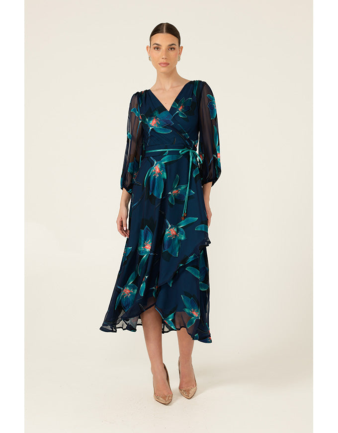 Woman wearing a dark blue floral dress on a white background