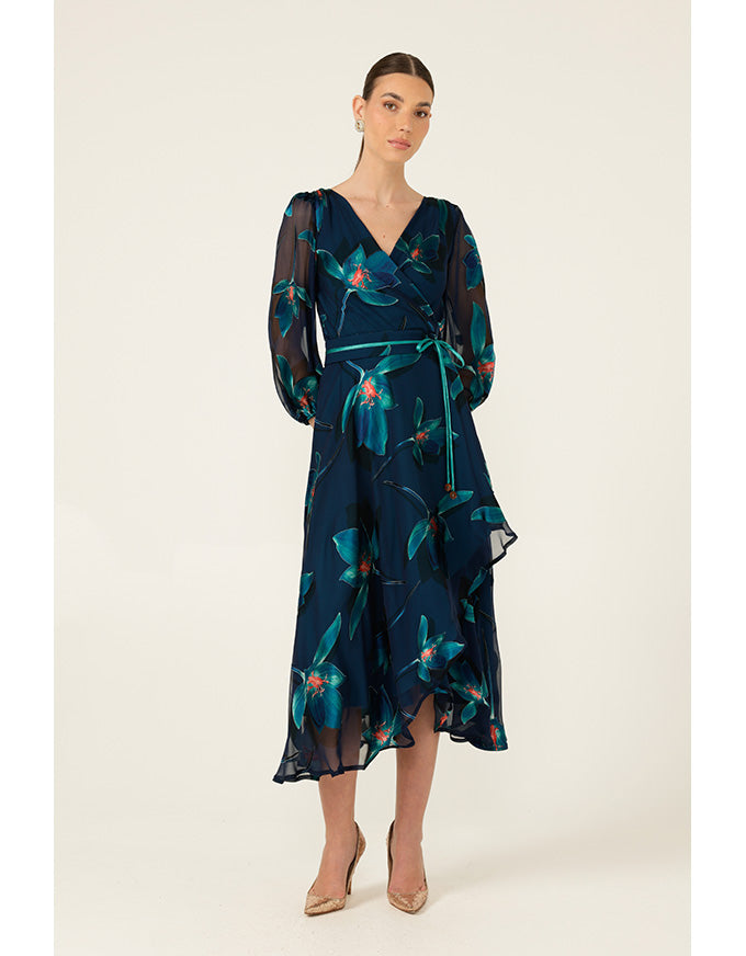 Woman wearing a dark blue floral dress on a white background
