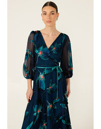 Woman wearing a dark blue floral dress on a white background