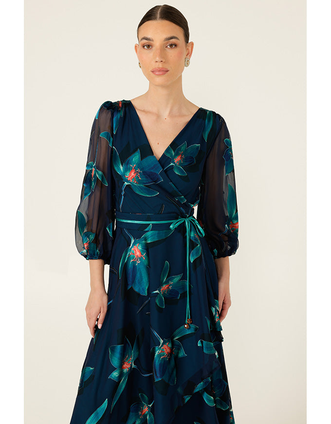 Woman wearing a dark blue floral dress on a white background