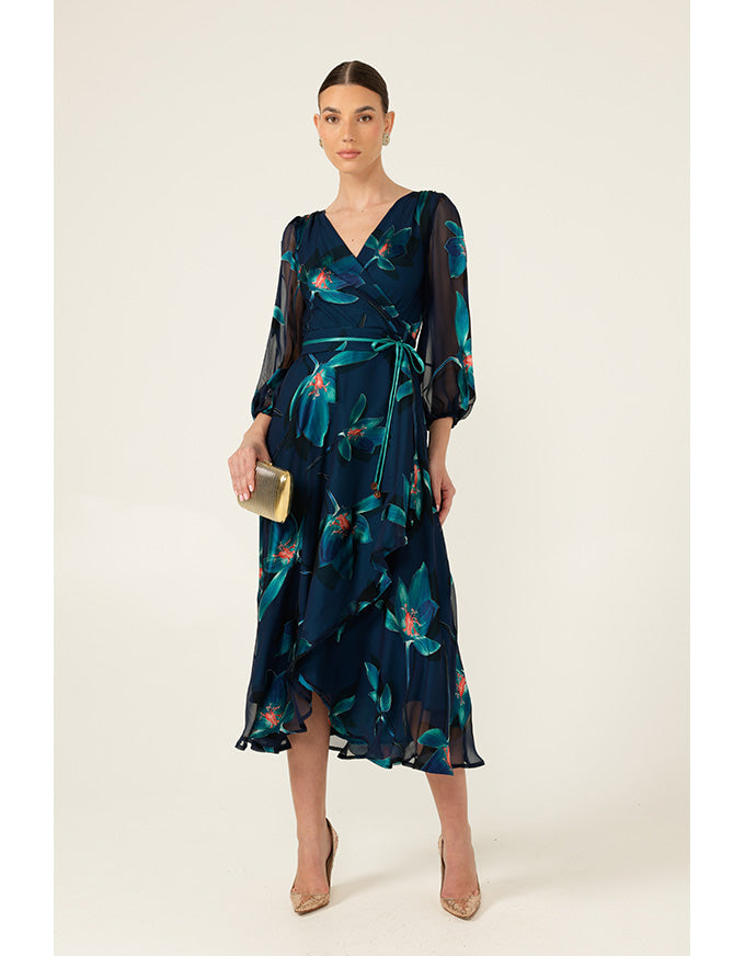 Woman wearing a dark blue floral dress on a beige background