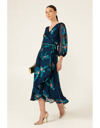 Woman wearing a dark blue floral dress on a white background
