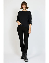 Woman wearing a black outfit with gray boots on a white background