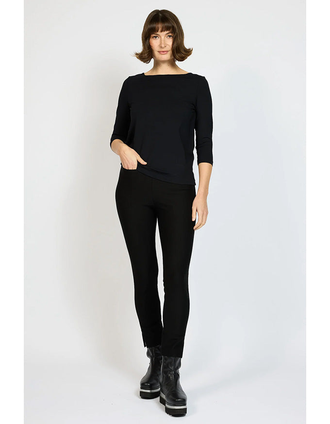 Woman wearing a black outfit with gray boots on a white background