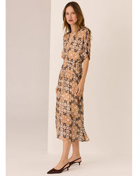 Woman wearing a floral dress against a plain background