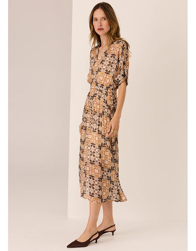 Woman wearing a floral dress against a plain background