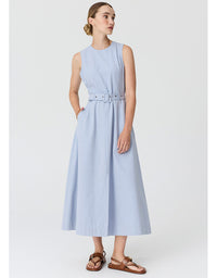 A woman modeling a sleeveless light blue midi dress with a matching belt, styled with brown leather sandals against a plain light gray studio background.