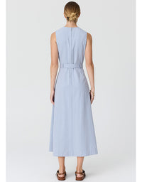 A woman viewed from the back wearing a sleeveless light blue midi dress with a matching waist tie, paired with brown sandals, against a light gray studio background.
