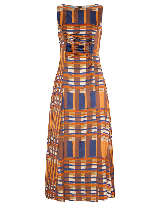 A sleeveless maxi dress with a pleated bodice and flowing skirt, featuring a geometric plaid pattern in orange, navy blue, brown, and white, shown against a plain white background.