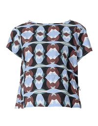 A short-sleeve top with a geometric, kaleidoscopic pattern featuring light blue, brown, white, and black shapes, displayed on a clean white background.