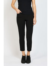 Person wearing black pants and black shoes on a white background