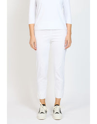 Person wearing a white outfit with white pants on a plain background