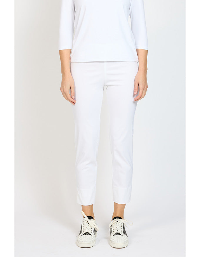 Person wearing a white outfit with white pants on a plain background
