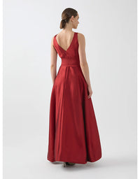 Woman wearing a red evening gown on a white background