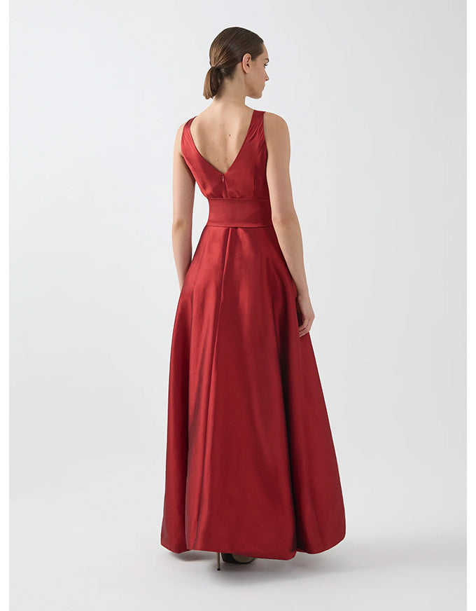 Woman wearing a red evening gown on a white background