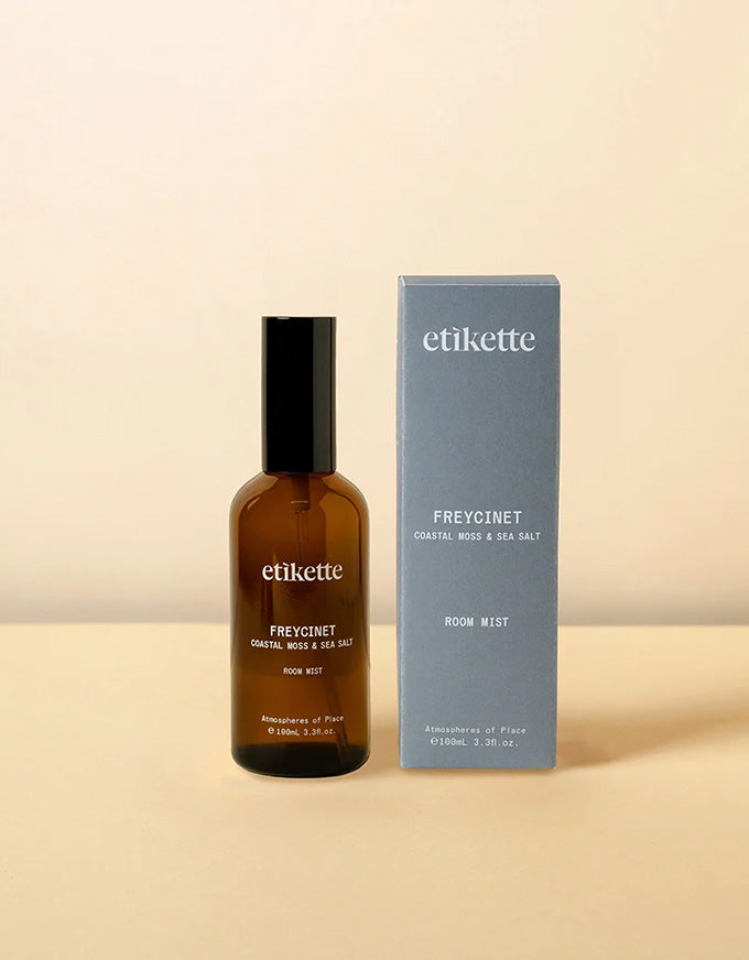 Brown bottle and blue box of etikette Freycinet room mist on a beige background