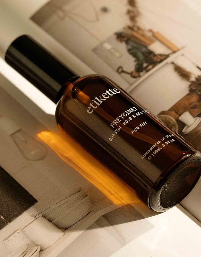 Brown bottle with 'etikette' branding on a shelf with a blurred background