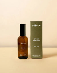 Brown bottle and green box of etikette Otways Room Mist on a beige background