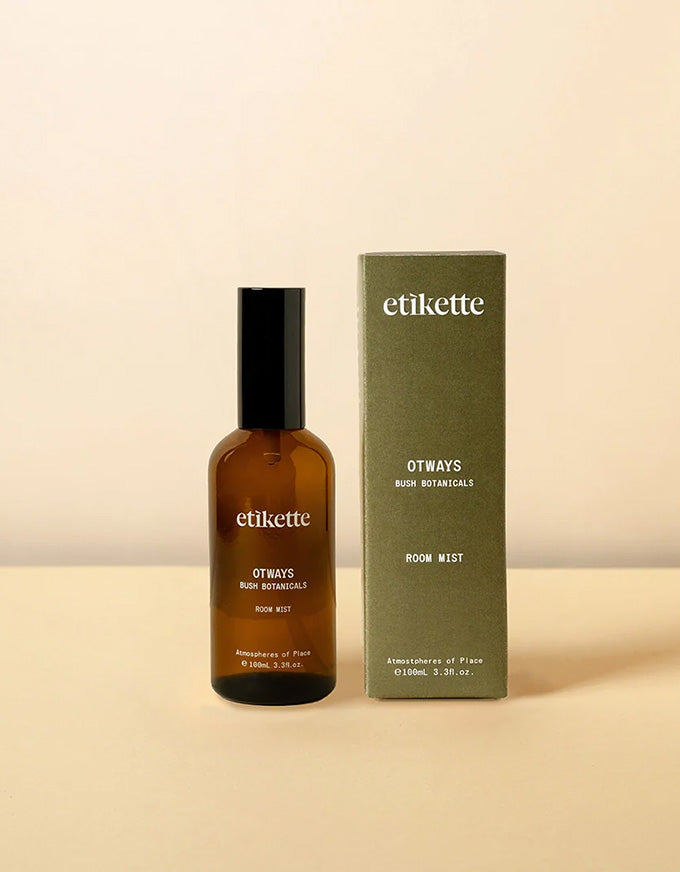 Brown bottle and green box of etikette Otways Room Mist on a beige background