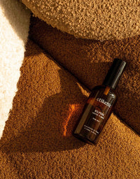 Elixit bottle on a textured brown surface