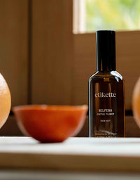 Brown bottle labeled 'etikette' with 'Wilpena Cactus Flower' on a surface with a blurred background