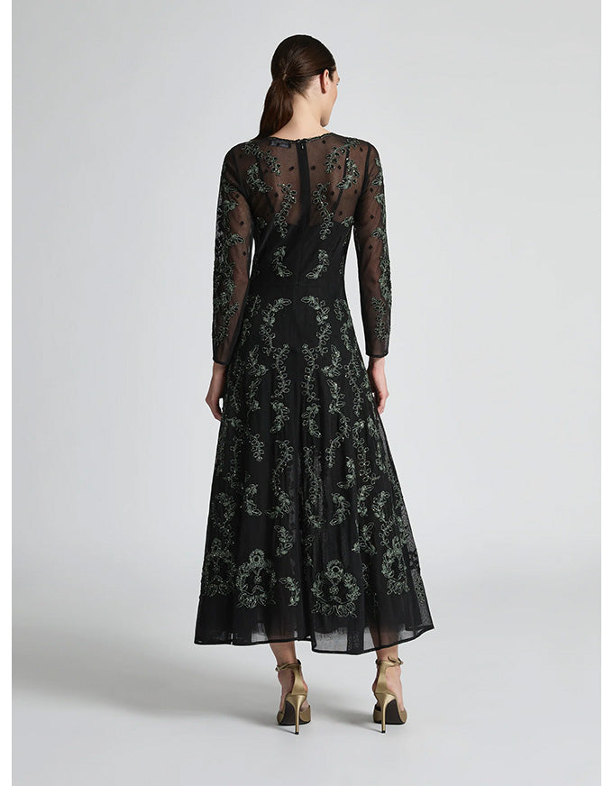 Woman wearing a black lace dress on a white background