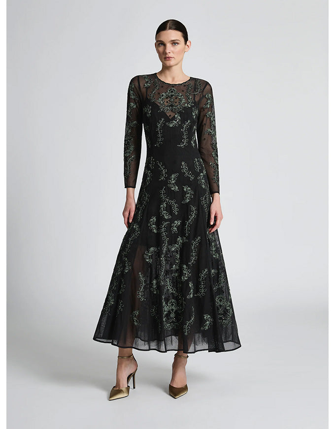 Woman wearing a black floral lace dress on a white background