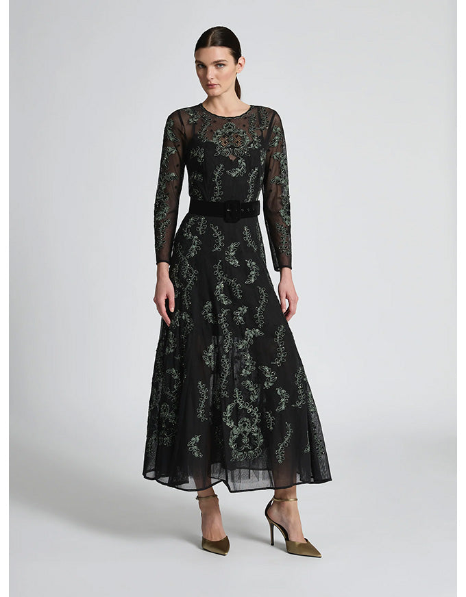 Woman wearing a black lace dress on a white background