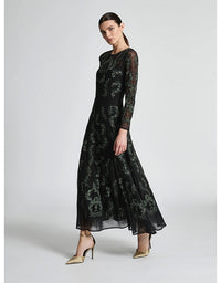 Woman wearing a black floral lace dress on a white background