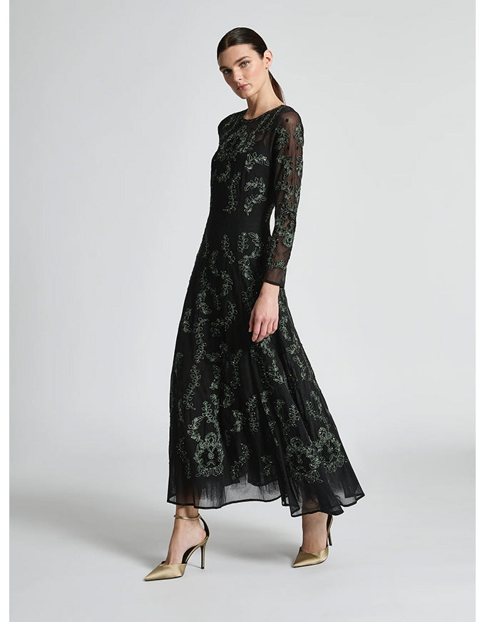 Woman wearing a black floral lace dress on a white background