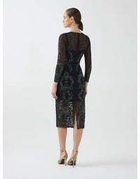Woman wearing a black lace dress on a white background