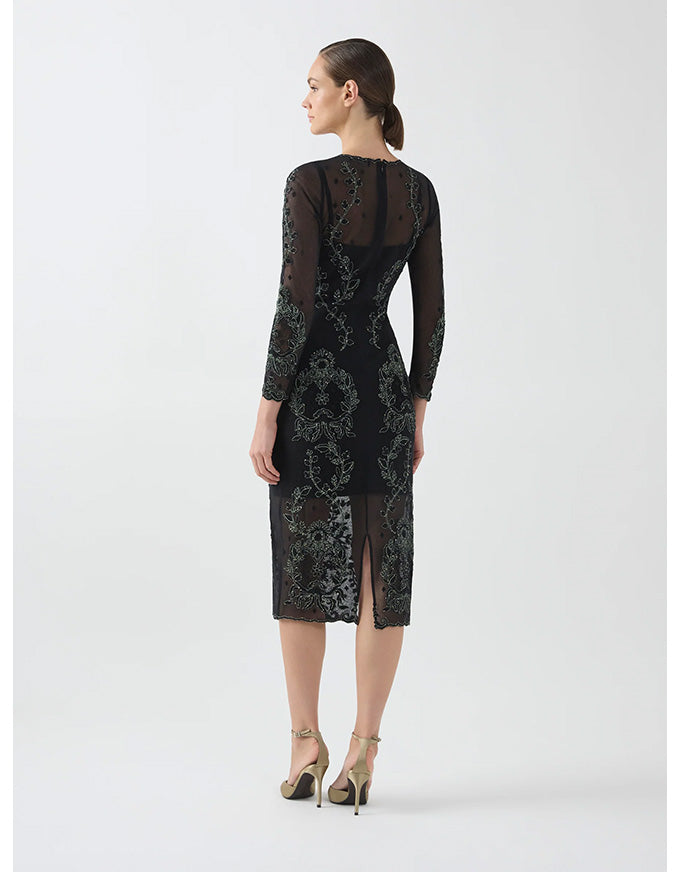 Woman wearing a black lace dress on a white background