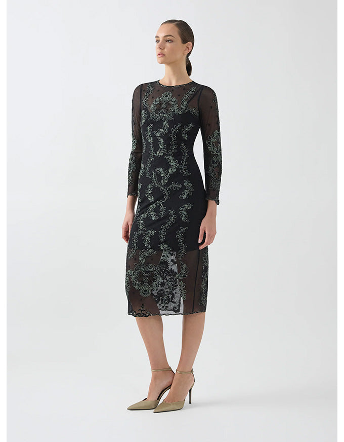 Woman wearing a black lace dress on a white background