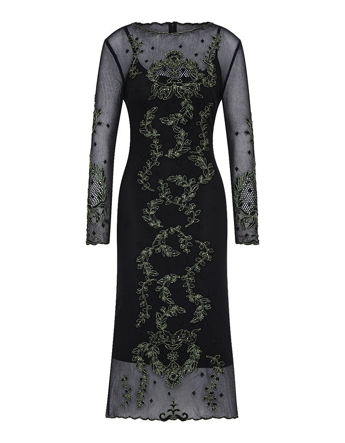 Black dress with intricate green embroidery on a white background