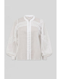 White blouse with sheer sleeves on a light gray background